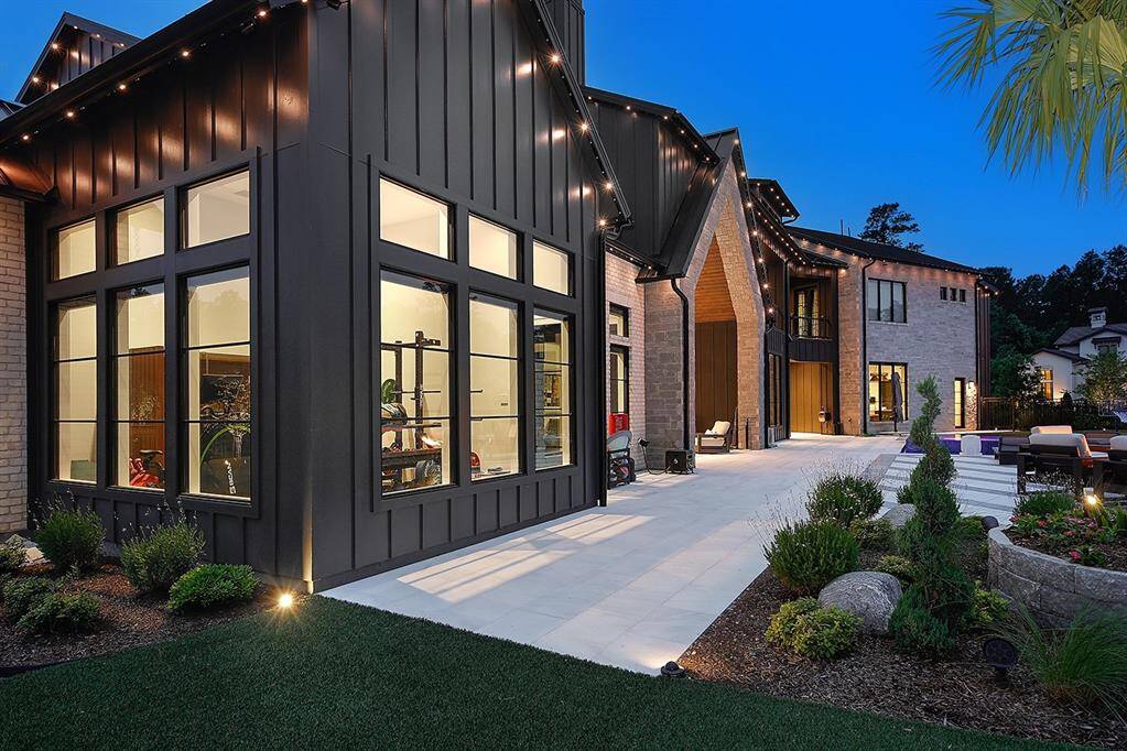 The back of the home has multiple covered patios, pet turf and Jellyfish and landscape lighting.