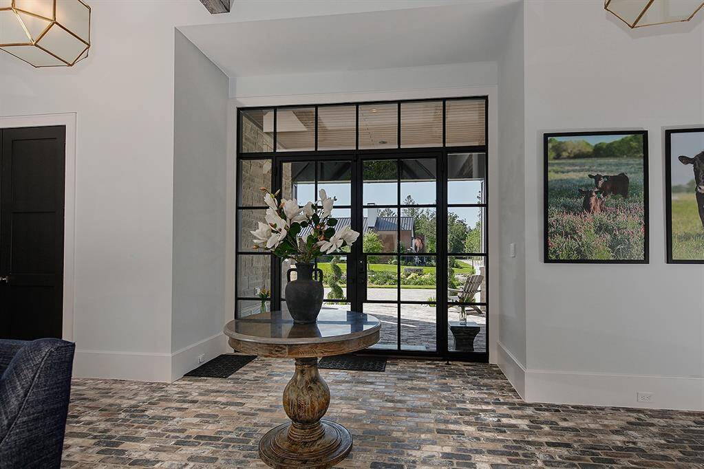 Dual glass and iron entry doors lead you inside, where you'll find that no expense has been spared in this spectacular home.