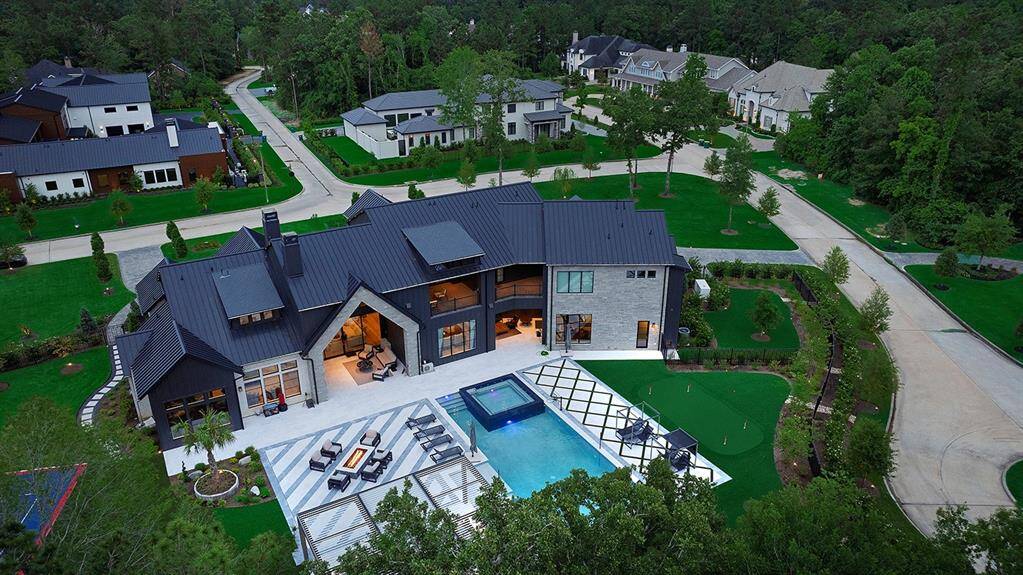 The resort style backyard also has a putting green, dog run area with pet turf connected to a doggy door, and an outdoor shower.