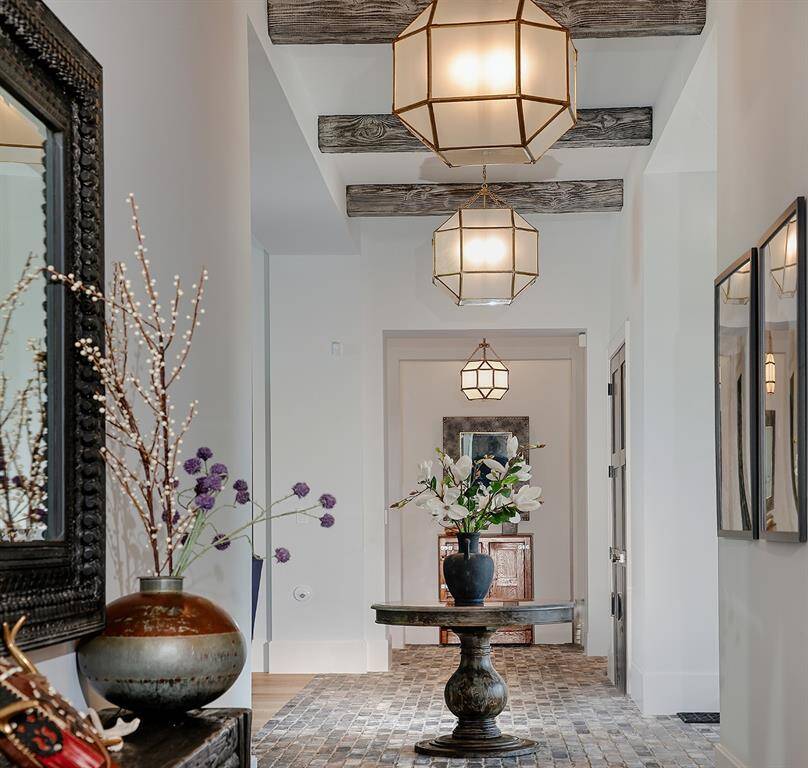 Real wood beams, Level 5 drywall with flat finish, and sealed brick walkway are just a few notable items you'll find in the foyer.