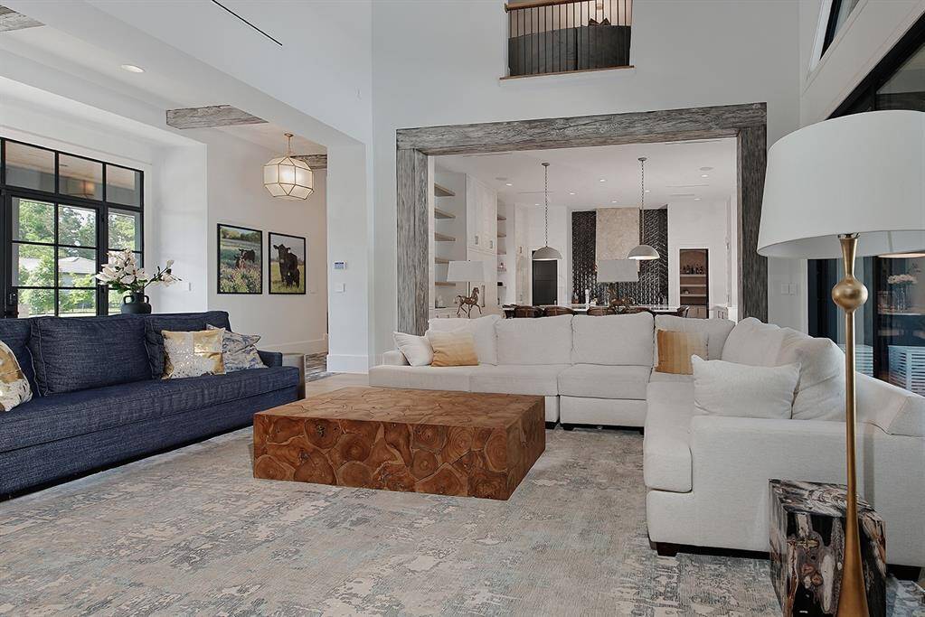 The living room opens to the expansive kitchen, leading you to the heart of the home.