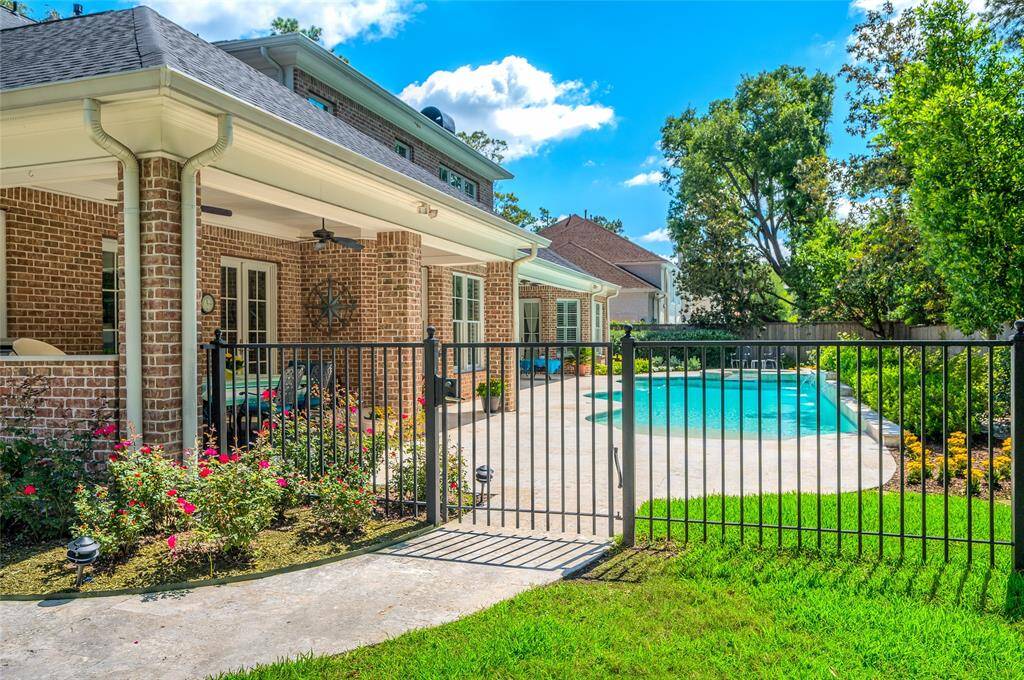 Iron fence from the driveway to the outdoor oasis