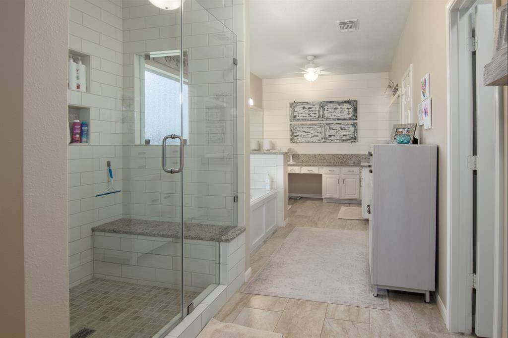 Now, into the primary bathroom. Lots of space here too! OVERSIZED shower, granite seat and jetted tub. The bathroom was updated in 2019.