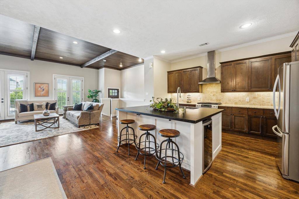 With direct access to the upstairs living area, the oversized island includes a built-in wine fridge and prep sink—perfect for entertaining with ease and style.