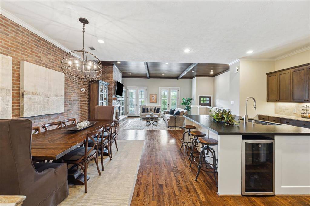 This expansive view showcases the home’s flowing layout—where rich textures, warm tones, and thoughtful finishes create a cohesive and inviting main living space.