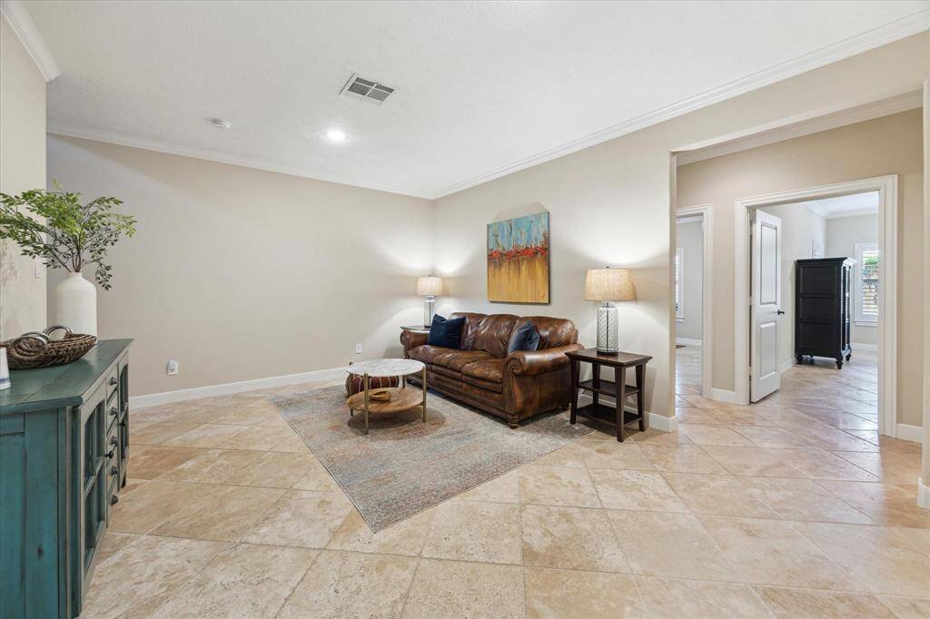 A versatile downstairs living area offers the perfect flex space for a media room, game room, or casual lounge—centrally located near both secondary bedrooms and full secondary bathroom.