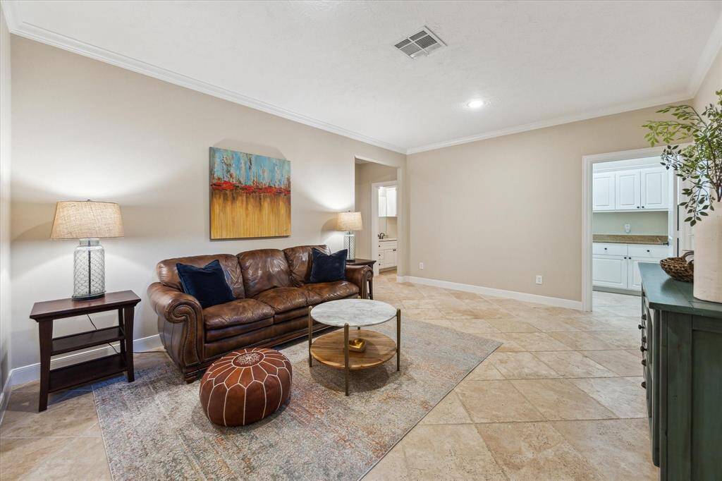 Whether you need a second family room, playroom, or home gym, this spacious bonus area features tile floors, crown molding, and convenient access to the laundry and full secondary bathroom.