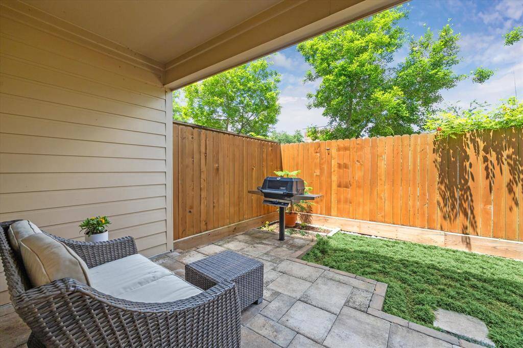 Relax or entertain in this low-maintenance backyard featuring a covered patio, built-in grill, and privacy fencing—perfect for quiet mornings or weekend BBQs.