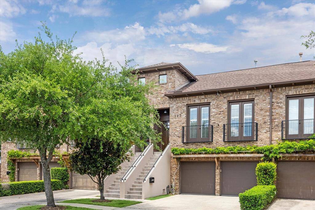 Mature trees frame the inviting brick exterior, while a private driveway offers rare guest parking—an added bonus in this coveted Heights location. Schedule your private tour today and experience the charm of 123 W 16th!