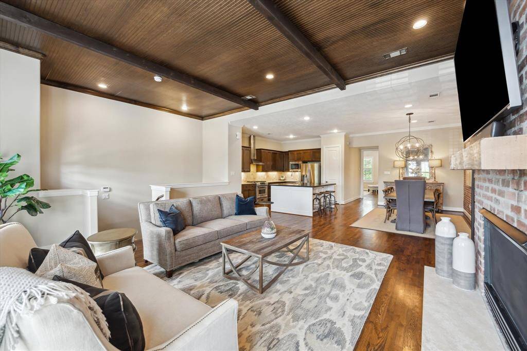 Enjoy effortless flow between the living, kitchen, and dining areas—ideal for entertaining or everyday comfort in this open-concept layout with designer finishes and warm hardwood flooring.