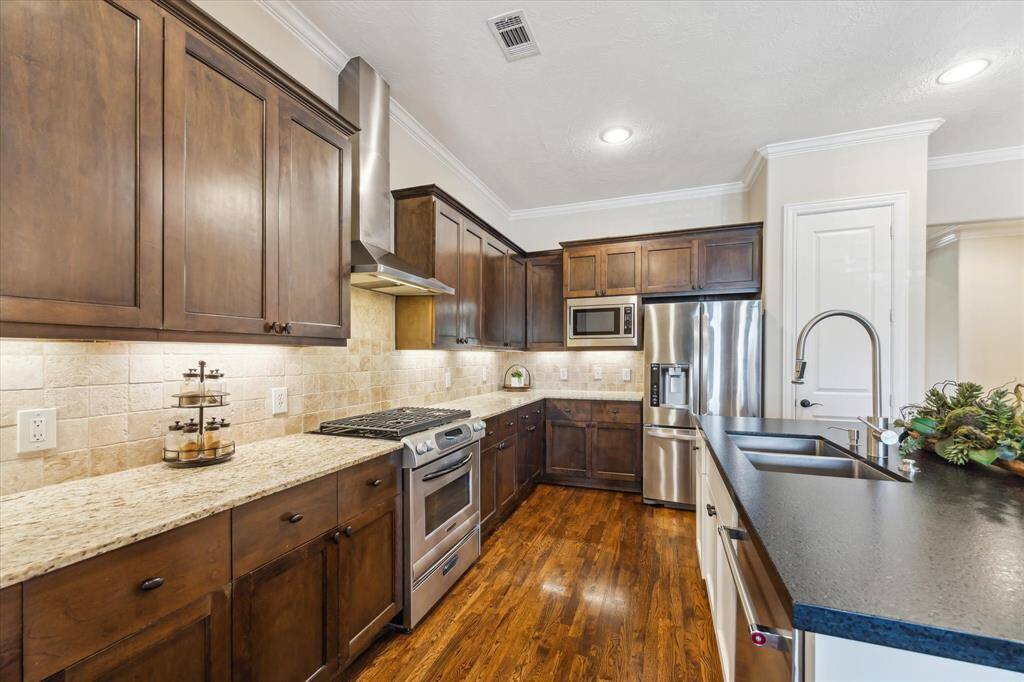 Enjoy ample cabinet space, stainless steel appliances, granite counters, and under-cabinet lighting—designed for both beauty and function in this chef-ready kitchen.