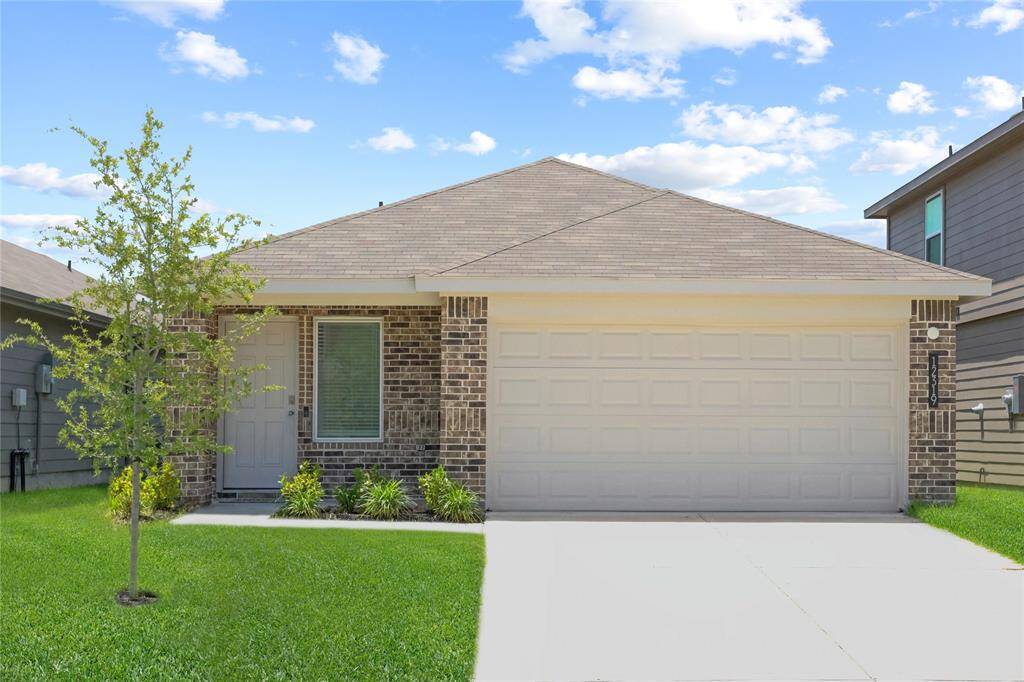 A balanced and clean look greets you at the curb—the charming brick facade is complemented by a neat green lawn and a smooth double-width driveway leading to the attached two-car garage.