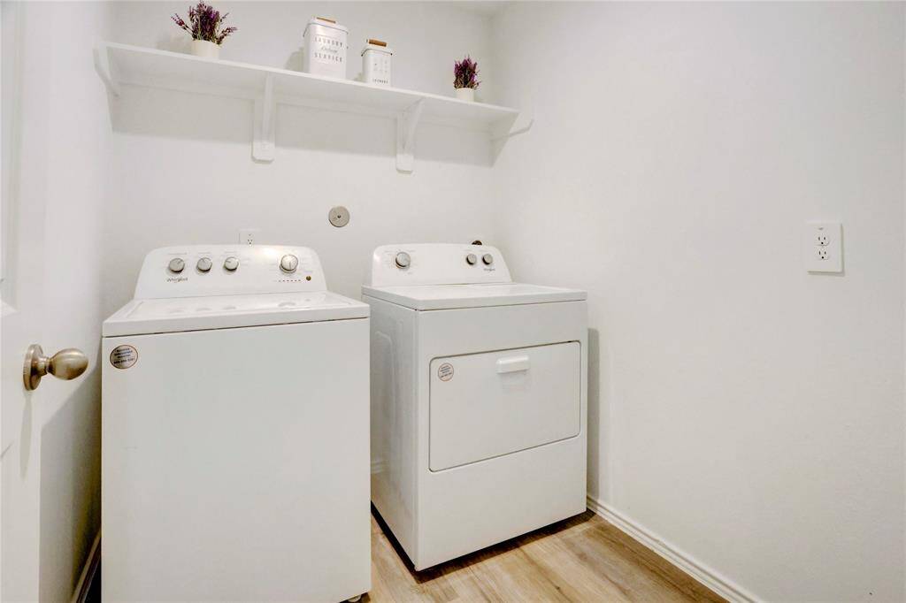 This utility space offers everything you need with room for side-by-side machines and a built-in overhead rack for convenient storage and organization.
