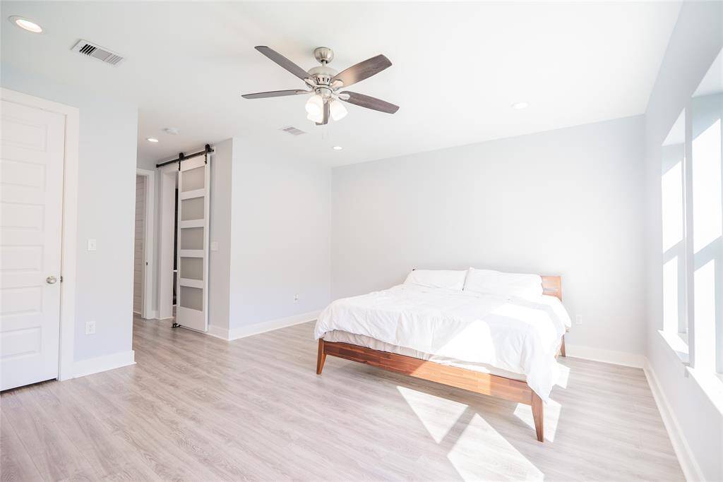Primary bedroom with barn door.