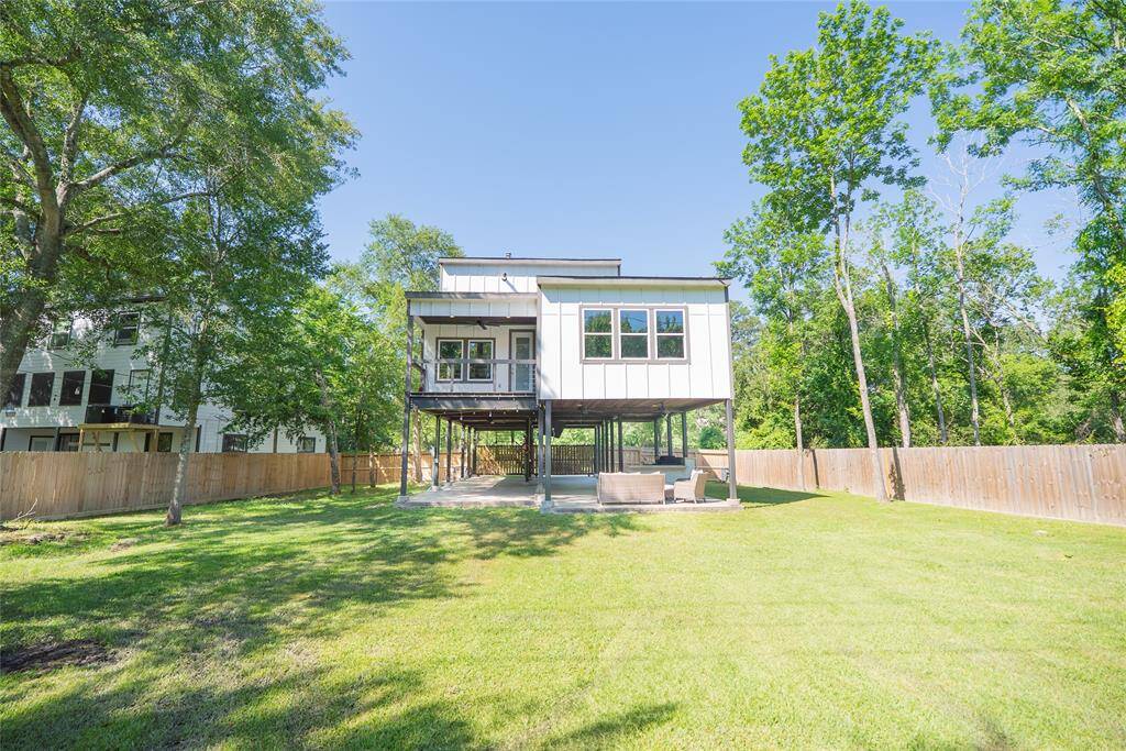 Rear view of the home, with beautiful shade trees.