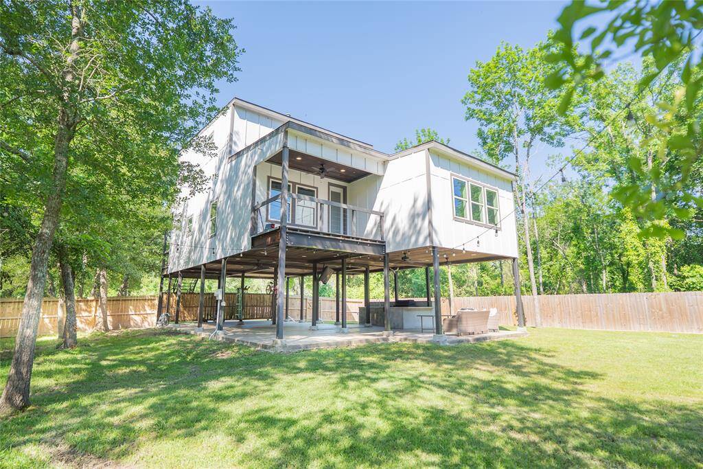 Back view of deck, shade trees and downstairs kitchen.