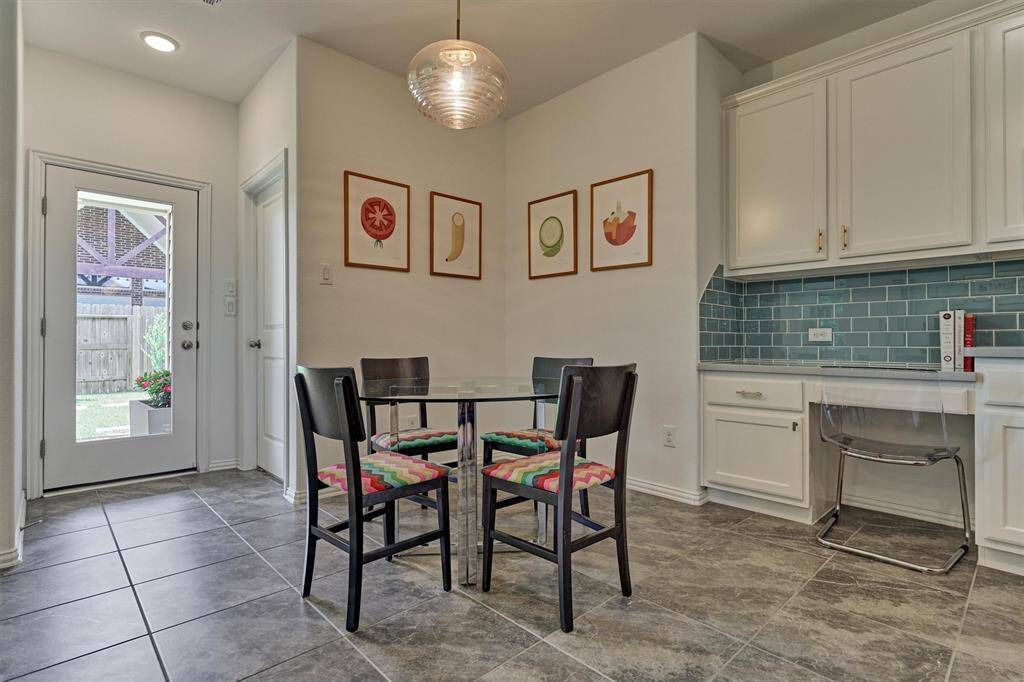 Light and bright, this breakfast room offers easy access to the rear patio - perfect for grilling!