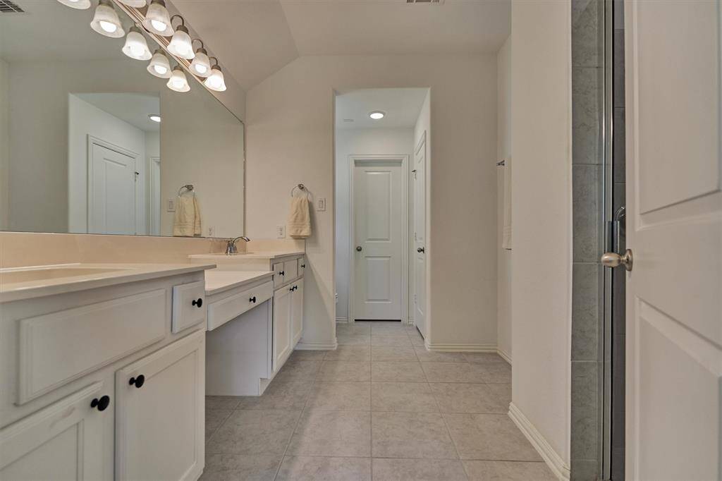 Primary bath is thoughtful in design with dual vanities and bonus prep area! Note the linen closet for additional storage options.