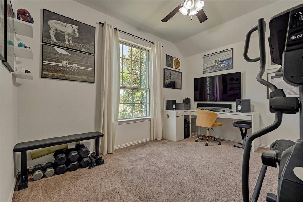 This spacious bedroom overlooks the quiet front yard and features a walk-in closet + raised ceiling.