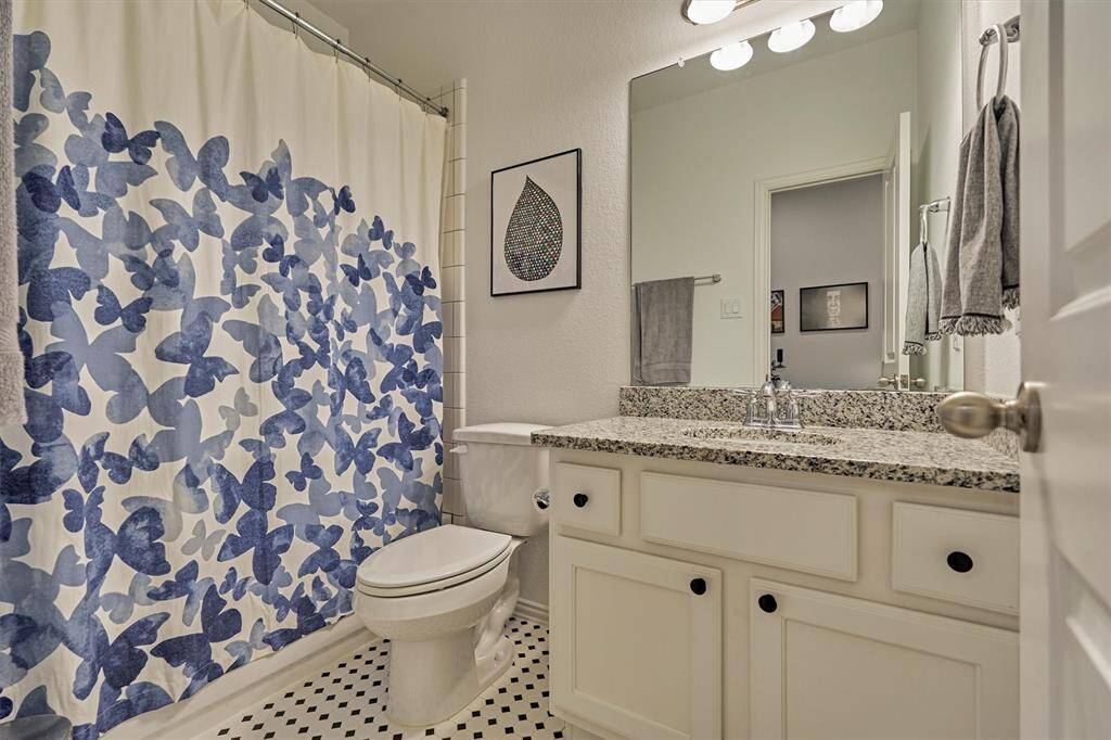 Well-appointed full bath with tub/shower combo and upgraded tile sits between the two secondary bedrooms.