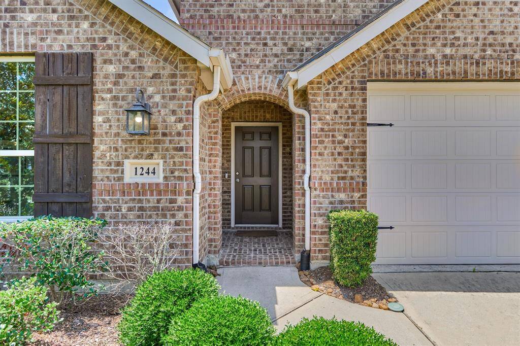 Freshly painted front door welcomes you home to this immaculate beauty in sought-after location! Note the brick elevation, wood shutters and corbel details that accentuate the curb appeal here!