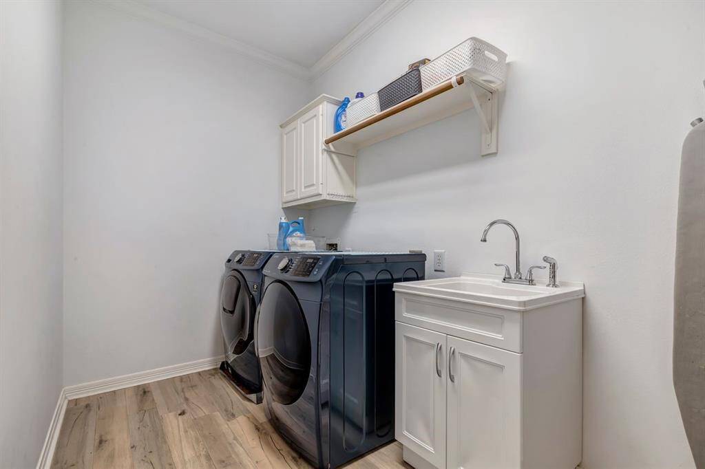 Laundry room upstairs with sink.