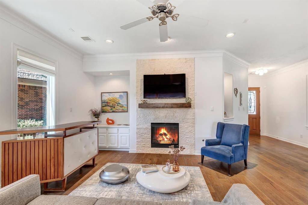 Stone accent fireplace with built in cabinets to the left side.