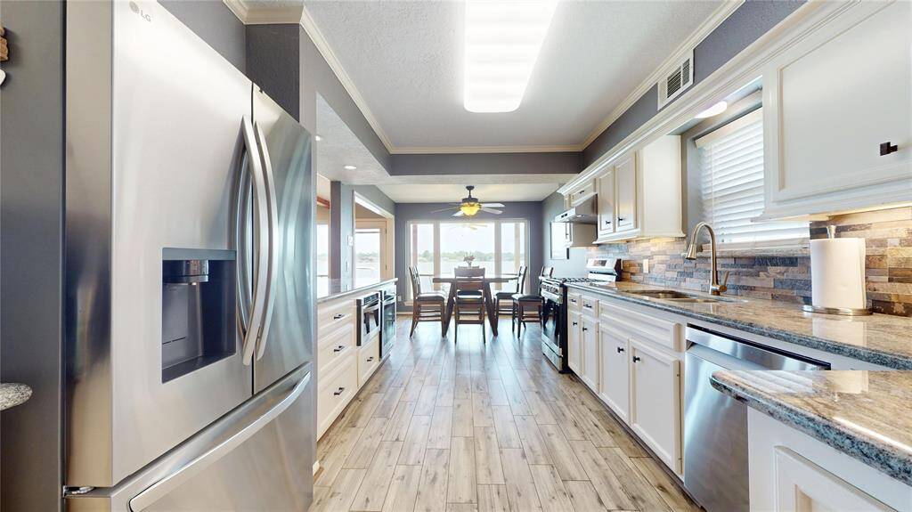 Discover the recently remodeled gourmet kitchen, featuring a gas range, electric wall oven, and convenient microwave drawer.