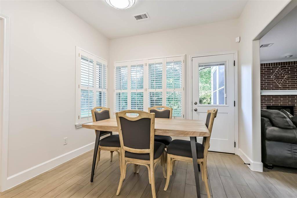 The breakfast room has plantation shutters and has views of the beautiful back yard.