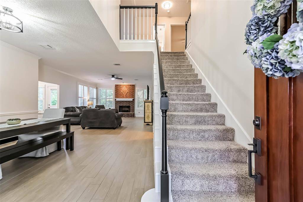 As soon as you walk through the front doors you are greeted by wood like tile floors that flow throughout the first level.