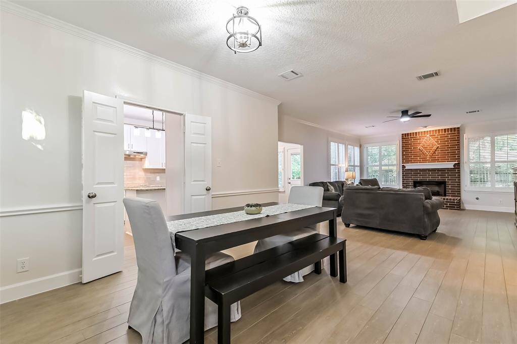 The formal dining room is to the left of the entry with an updated light fixture, chair railings and crown molding.