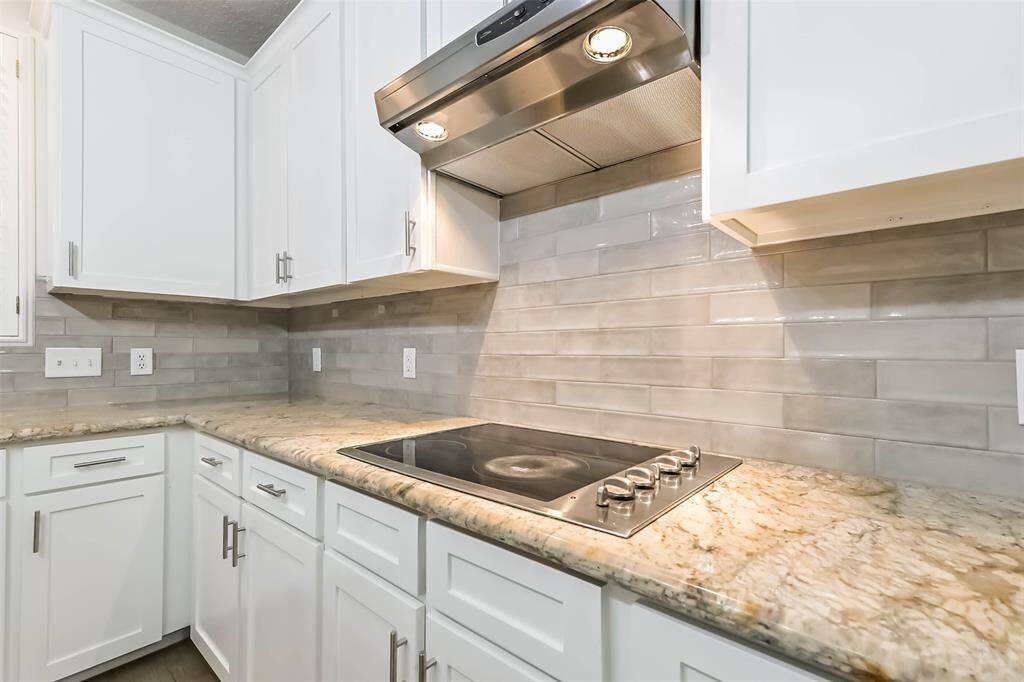 There is an electric cooktop with vent in the island kitchen.