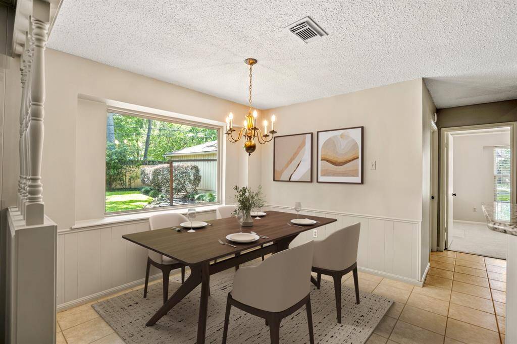 Cozy eat-in kitchen area with a large window that brings in tons of natural light—perfect spot for your morning coffee. - VIRTUALLY STAGED