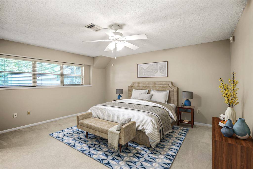 The primary bedroom is located on the main floor and features plenty of space, a walk-in closet, and a split bath with its own private vanity. - VIRTUALLY STAGED