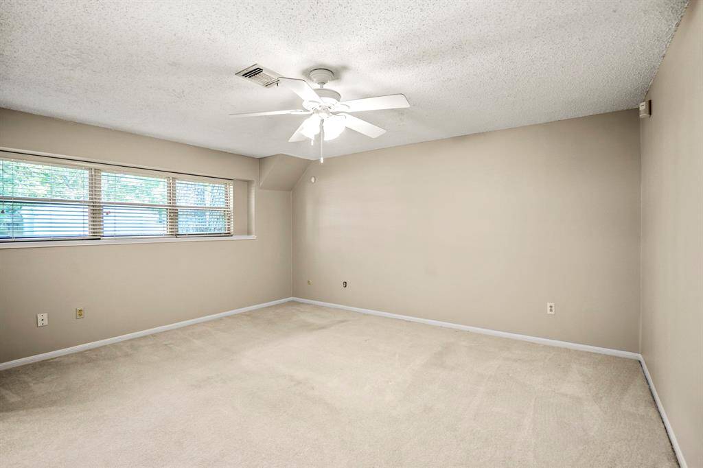 The primary bedroom is located on the main floor and features plenty of space, a walk-in closet, and a split bath with its own private vanity.
