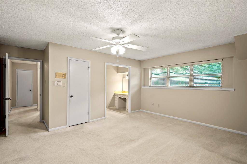 The primary bedroom is located on the main floor and features plenty of space, a walk-in closet, and a split bath with its own private vanity.