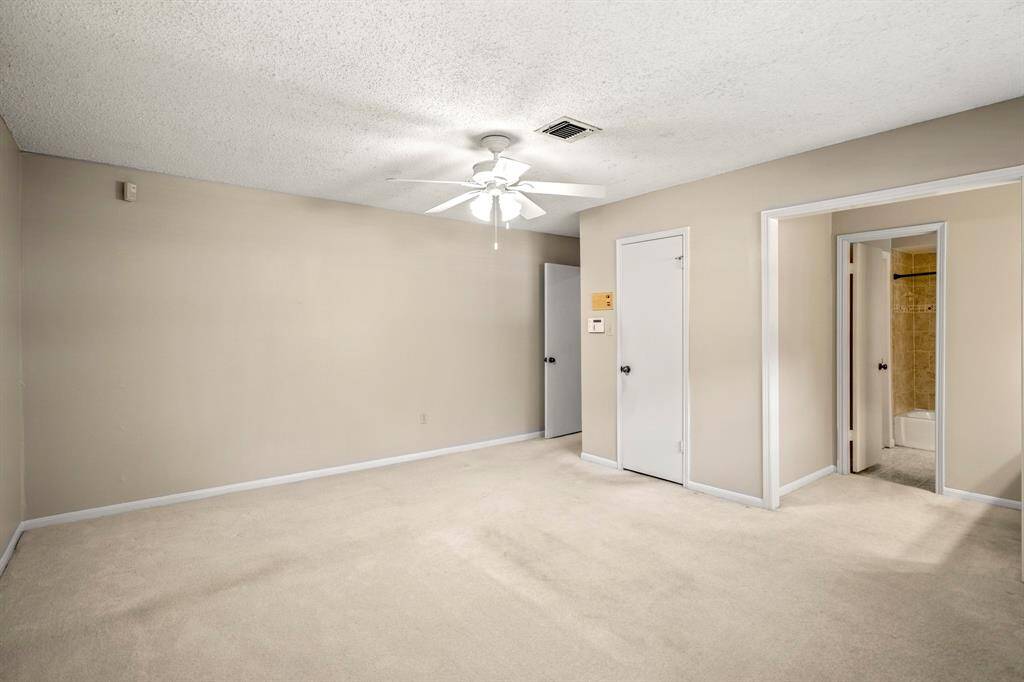 The primary bedroom is located on the main floor and features plenty of space, a walk-in closet, and a split bath with its own private vanity.