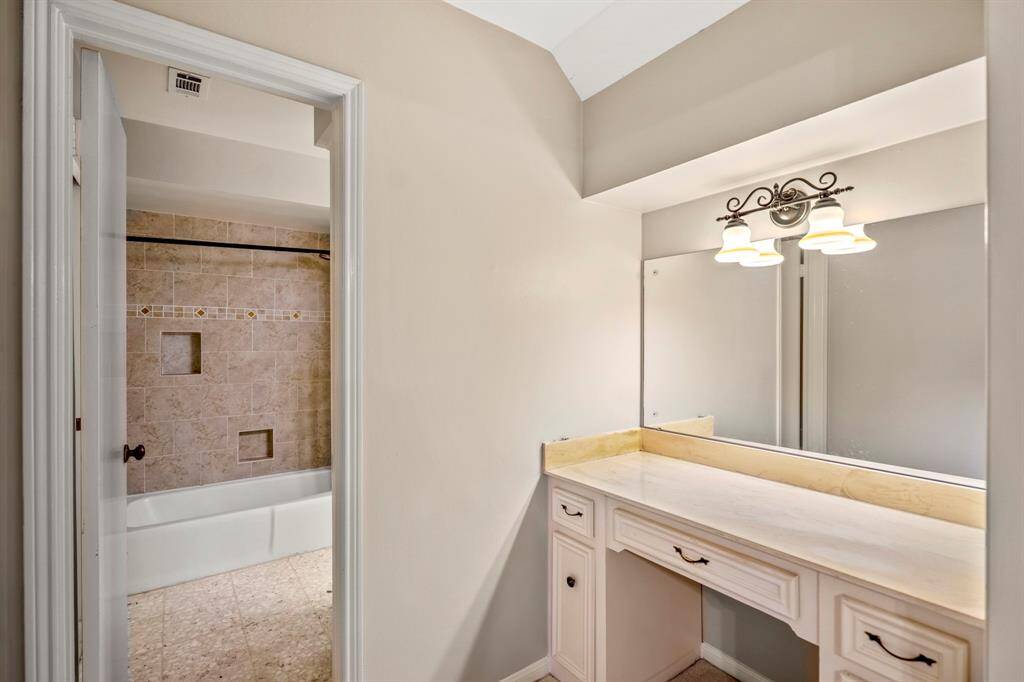 Private vanity leading to bathroom.