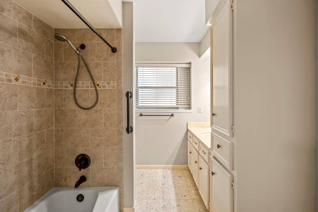 Enjoy a functional layout in the primary bath with a tub/shower combo, built-in shelving, and dual vanity access.