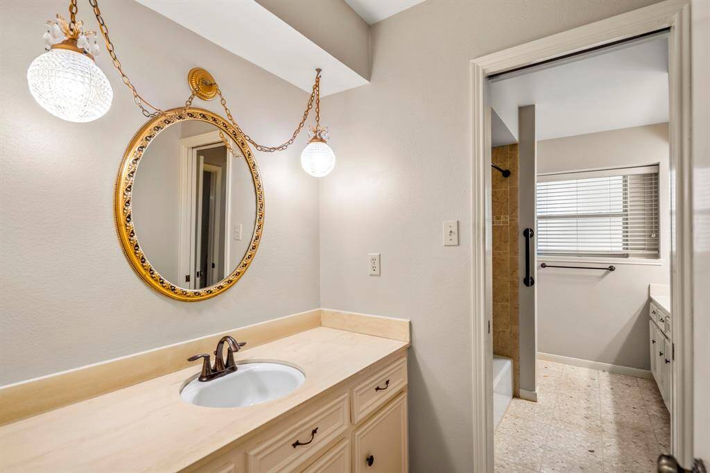 Guest vanity is located in the hallway and leads to the bathroom.