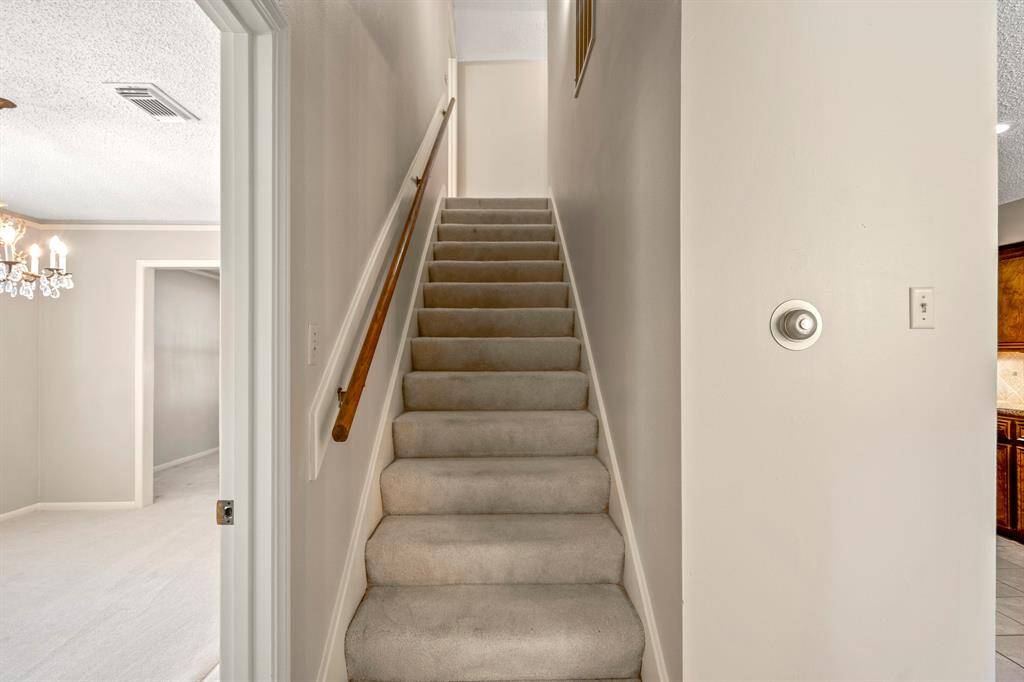 Tucked-away staircase design keeps the layout feeling open and clutter-free—great placement for everyday living.