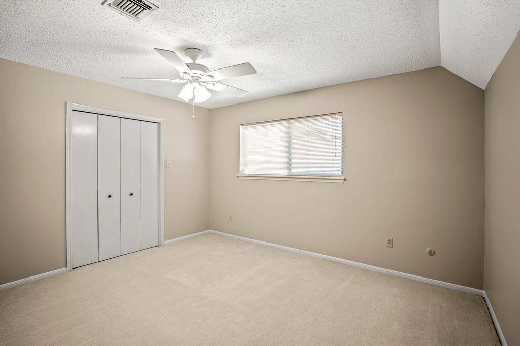 Upstairs Bedroom #2 features a large layout, walk-in closet, and a charming built-in desk that adds character and convenience.