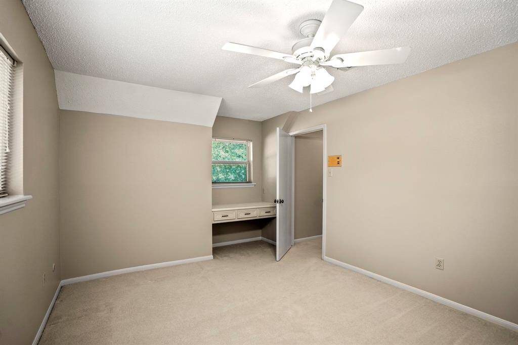 Upstairs Bedroom #2 features a large layout, walk-in closet, and a charming built-in desk that adds character and convenience.