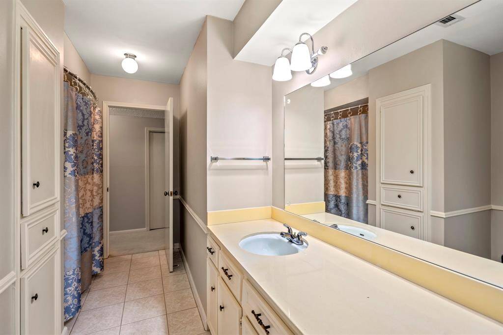 Roomy second bathroom with double sinks, great storage, and a classic shower/tub combo—perfect for busy mornings.