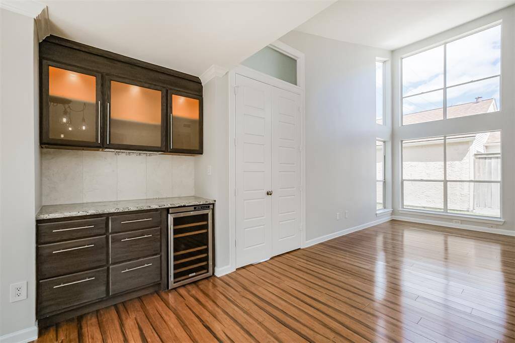 There is a dry bar in the dining room with a mini wine fridge and granite counters.