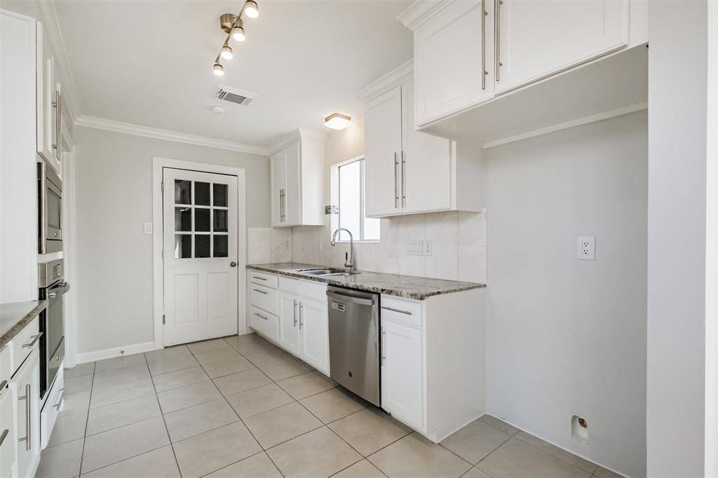 There is a SS dishwasher, tile floors and double basin sink in the kitchen.