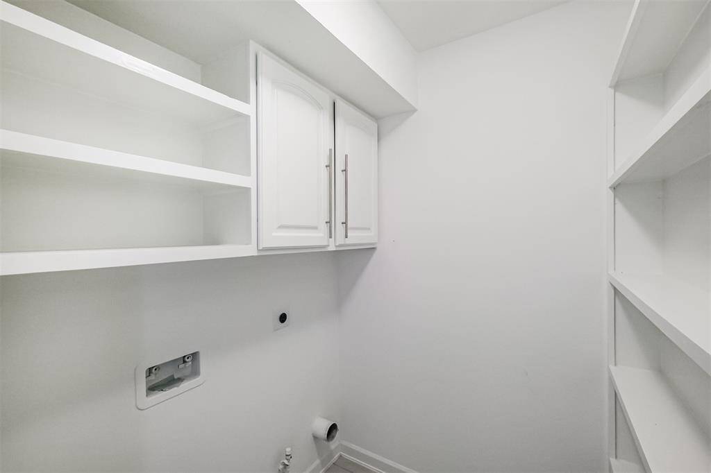 The walk-in pantry also accommodates a full size washer and dryer.