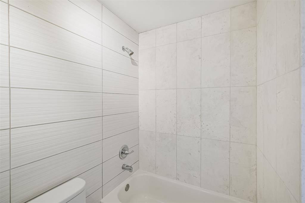The tub+shower duo has been updated with tile surround in the second full bathroom.
