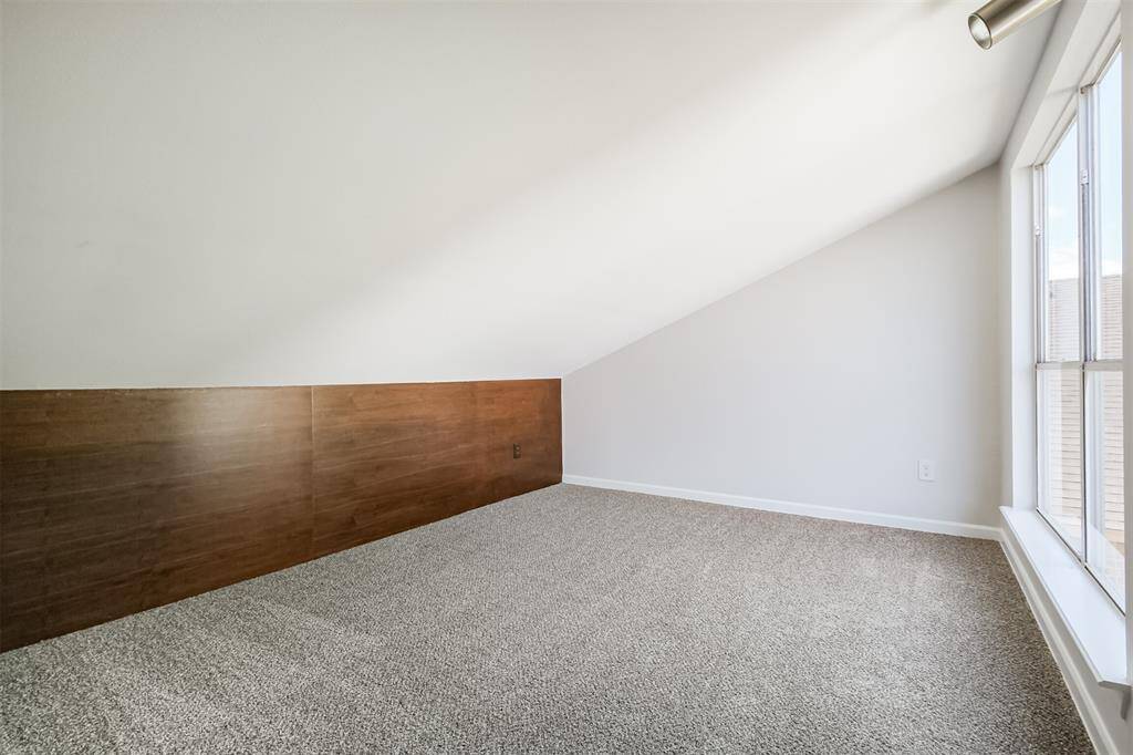 Upstairs is the game room with recent carpet floors (April 2025) and lots of natural lighting.