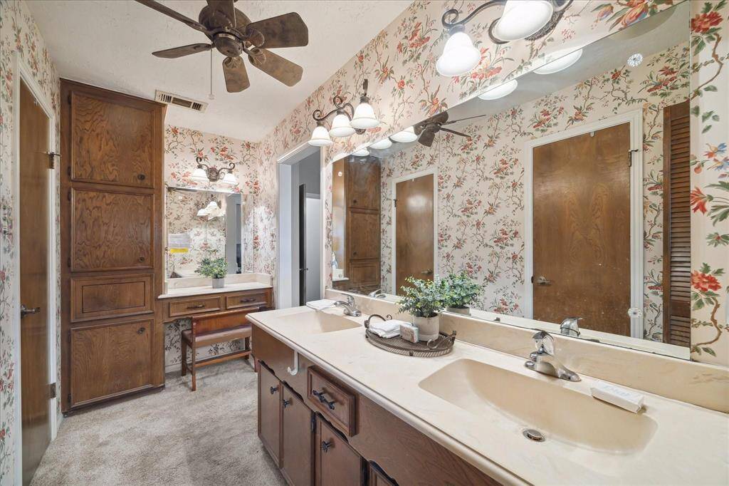 Large Primary Suite Bathroom with large dual sink vanity and separate mirror/vanity area / built-in cabinetry.